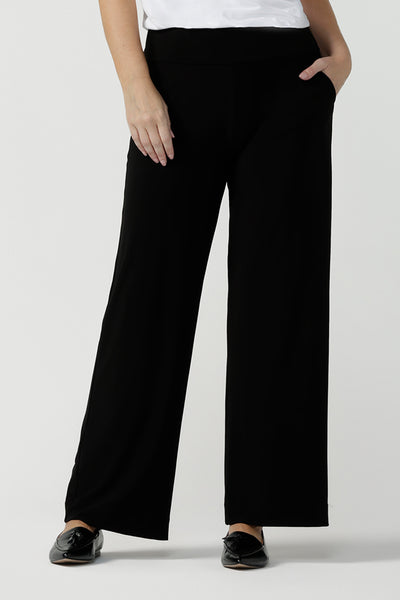 Close up image of womens size inclusive work pants. Pictured on a size 8 in black comfortable corporate pants. Full length straight leg pants