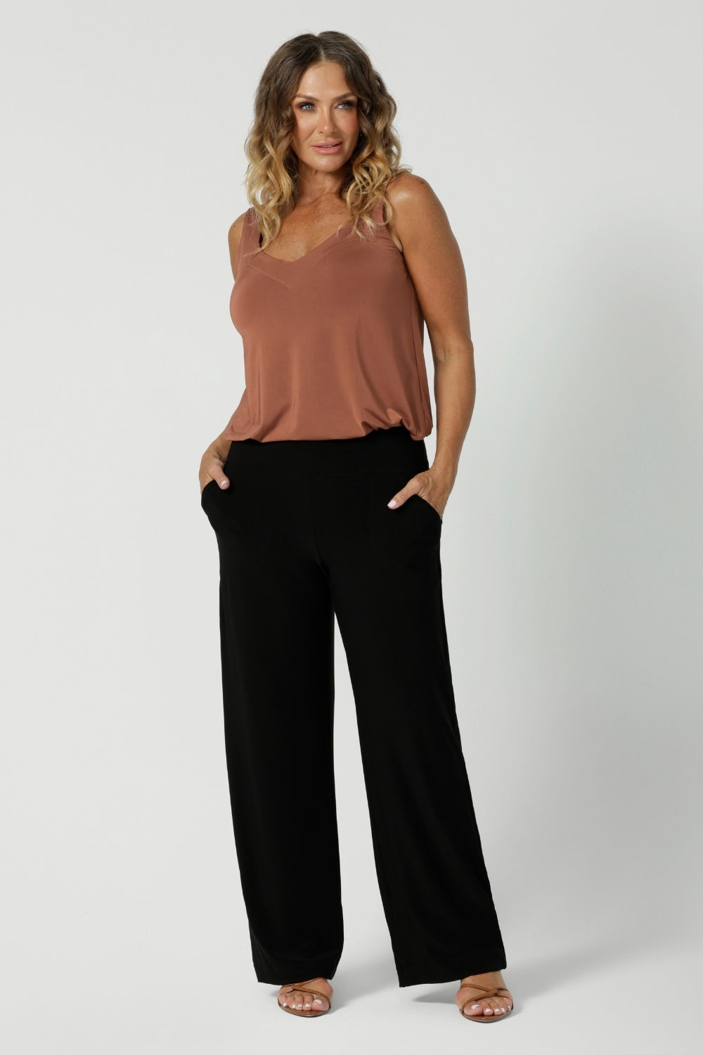 Black workwear pants have a pull on style and a wide straight leg. Crafted with dry touch jersey fabric in Australia for the woman on the go. Shop online at Australian women's fashion brand Leina & Fleur in a variety of sizes from 8-24. Monroe Pant now available in 3 heights.