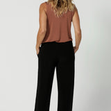 Back image of size 12 model in her 40's wearing back to work black pants. Monroe  Pants feature a pull on easy style, with a full length straight leg. Made with easy care, heavy weight, dry touch jersey fabric in Australia for the woman on the go. Shop Leina & Fleur core products in a variety of sizes from 8-24. The Monroe Pant now is available in 3 heights.