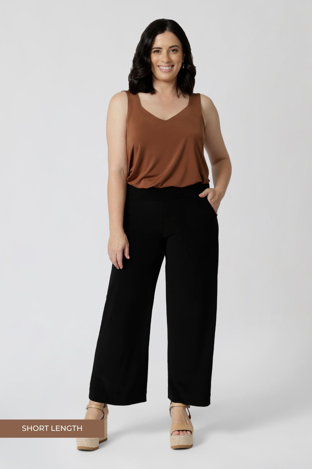 Petite height woman wears back-to-work full length, black pants. Easy care pants are Australian made with dry touch jersey fabric. Made in Australia for Australian & New Zealand women on the go. Leina & Fleur proudly stocks sizes from 8-24. Model wears short length pants in size 10.