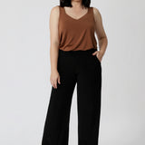 Petite height woman wears back-to-work full length, black pants. Easy care pants are Australian made with dry touch jersey fabric. Made in Australia for Australian & New Zealand women on the go. Leina & Fleur proudly stocks sizes from 8-24. Model wears short length pants in size 10.