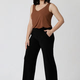 Black workwear pants seen on sizes 10 model, feature a full length, wide leg pull on style. Easy care fabric used to craft these pants is dry touch jersey fabric. Made in Australia for the Australian & New Zealand women on the go. Leina & Fleur proudly stocks sizes from 8-24. Model wears short length pants in size 10.