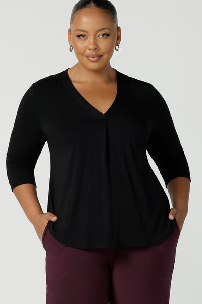 Black Bamboo pleat front top on a size 18 curvy woman. With a 3/4 sleeve and high-low hem, this top is a great women’s work top for corporate wear.  Styled back with a mulberry workwear corporate pant. Designed and made in Australia for women sizes 8 - 24. Leina and Fleur. 