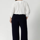 Back view image of Women's size inclusive work pants. Pictured on a size 18 woman, these comfortable navy corporate pants. Full length navy, straight leg pants with stretch. Shop in sizes 8-24. 