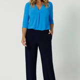 Women's size inclusive work pants. Pictured on a size 12 woman, these comfortable navy corporate pants. Full length navy, straight leg pants with stretch. Shop in sizes 8-24.