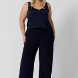 Full length, navy pants worn by plus size woman. Ideal for the woman on the go. Providing a great edition to any corporate wardrobe. Made with dry touch jersey fabric in Australia by fashion brand Leina & Fleur. Shop now in sizes 8-24 and with 3 length options. 