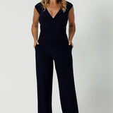 Navy workwear pants worn by 40's woman. Made with easy care, dry touch jersey fabric that provides long lasting quality and comfort. Available in sizes 8-24, with 3 height length options. 