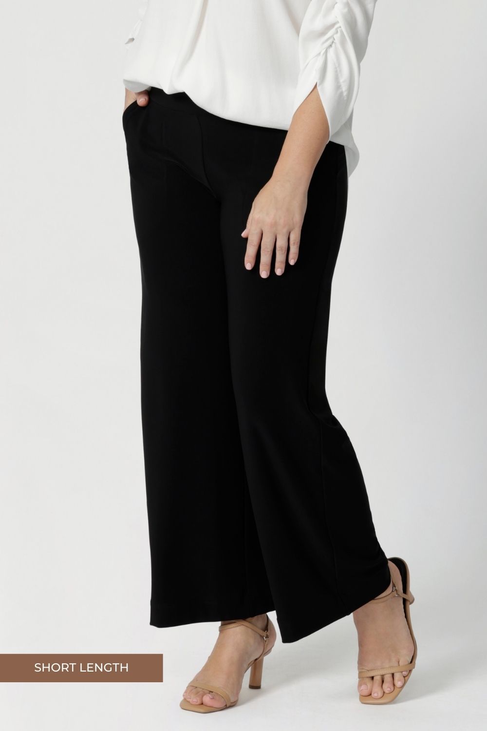 Close up image of black workwear pants that are petite height friendly. Shop online at Australian women's fashion brand Leina & Fleur in a variety of sizes from 8-24. Our Monroe Pants are now available in 3 heights. Shop long, regular and short length back to work pants. 