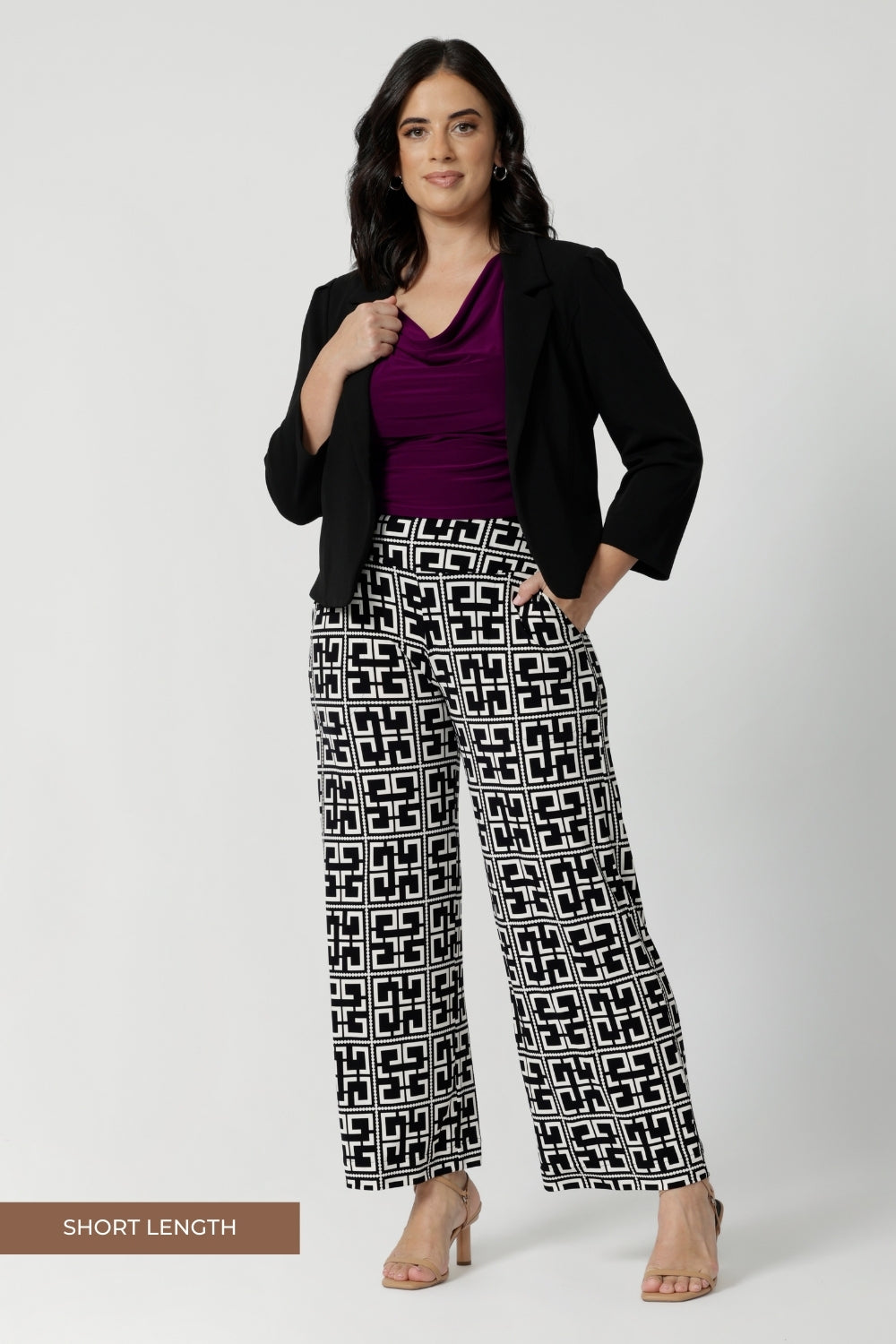 Perfectly paired with blazers from our soft suiting collection, the Monroe Pant is an essential for any professional wardrobe. Petite height woman wears short length Monroe Pants with magenta coloured top and black jacket blazer.