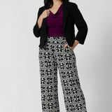 Perfectly paired with blazers from our soft suiting collection, the Monroe Pant is an essential for any professional wardrobe. Petite height woman wears short length Monroe Pants with magenta coloured top and black jacket blazer.