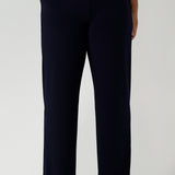 Close up of a tall woman curvy size 16 model wears Monroe Tall pants in navy. Great work pants for tall women. Comfortable work pants in navy jersey. Made in Australia size 8 - 24.