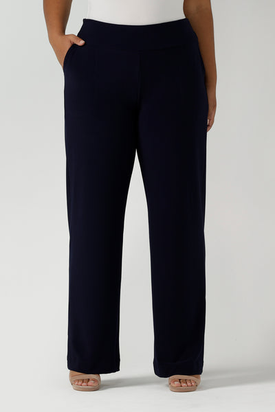 Close up of a tall woman curvy size 16 model wears Monroe Tall pants in navy. Great work pants for tall women. Comfortable work pants in navy jersey. Made in Australia size 8 - 24.