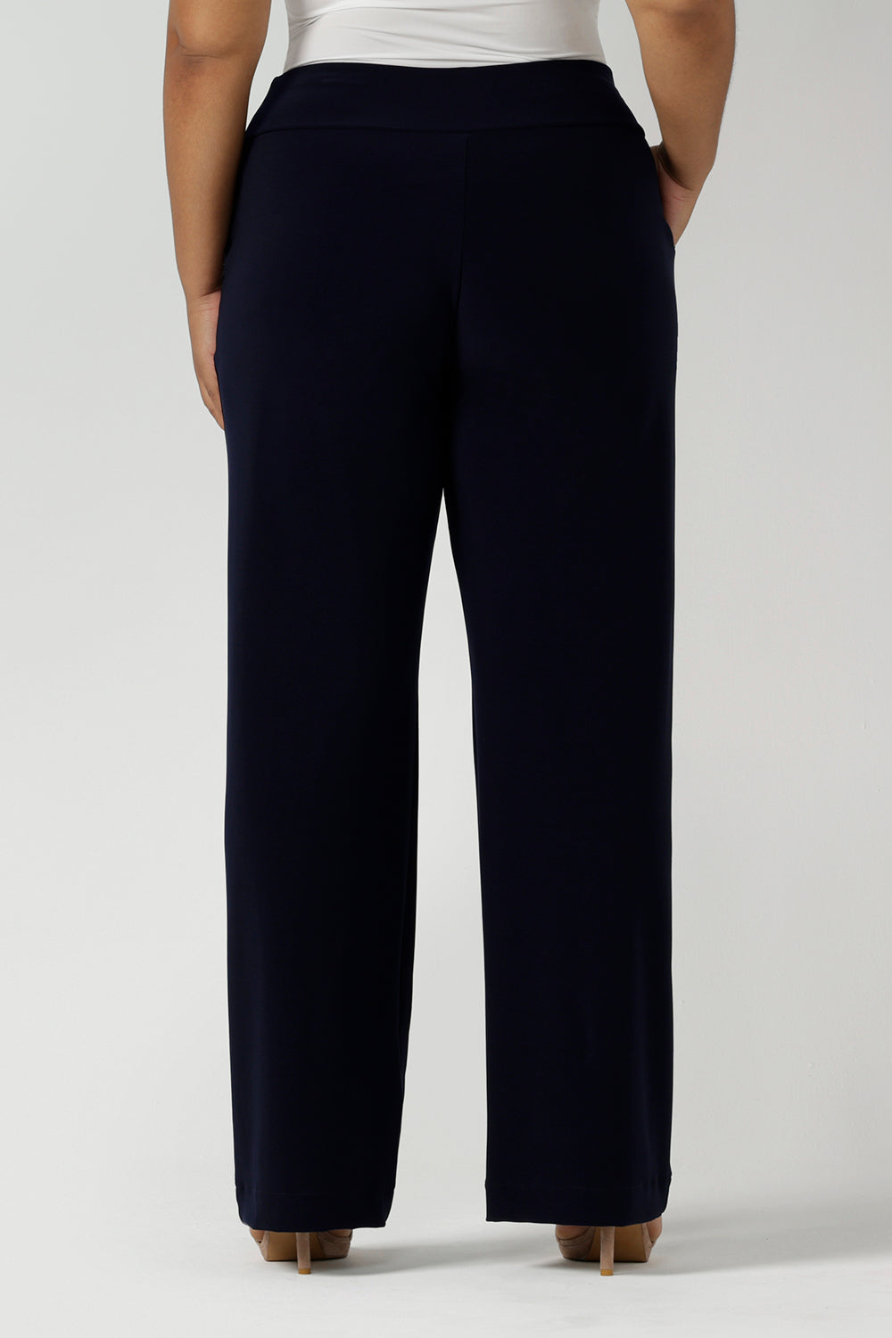 Back view of a tall woman curvy size 16 model wears Monroe Tall pants in navy. Great work pants for tall women. Comfortable work pants in navy jersey. Made in Australia size 8 - 24.