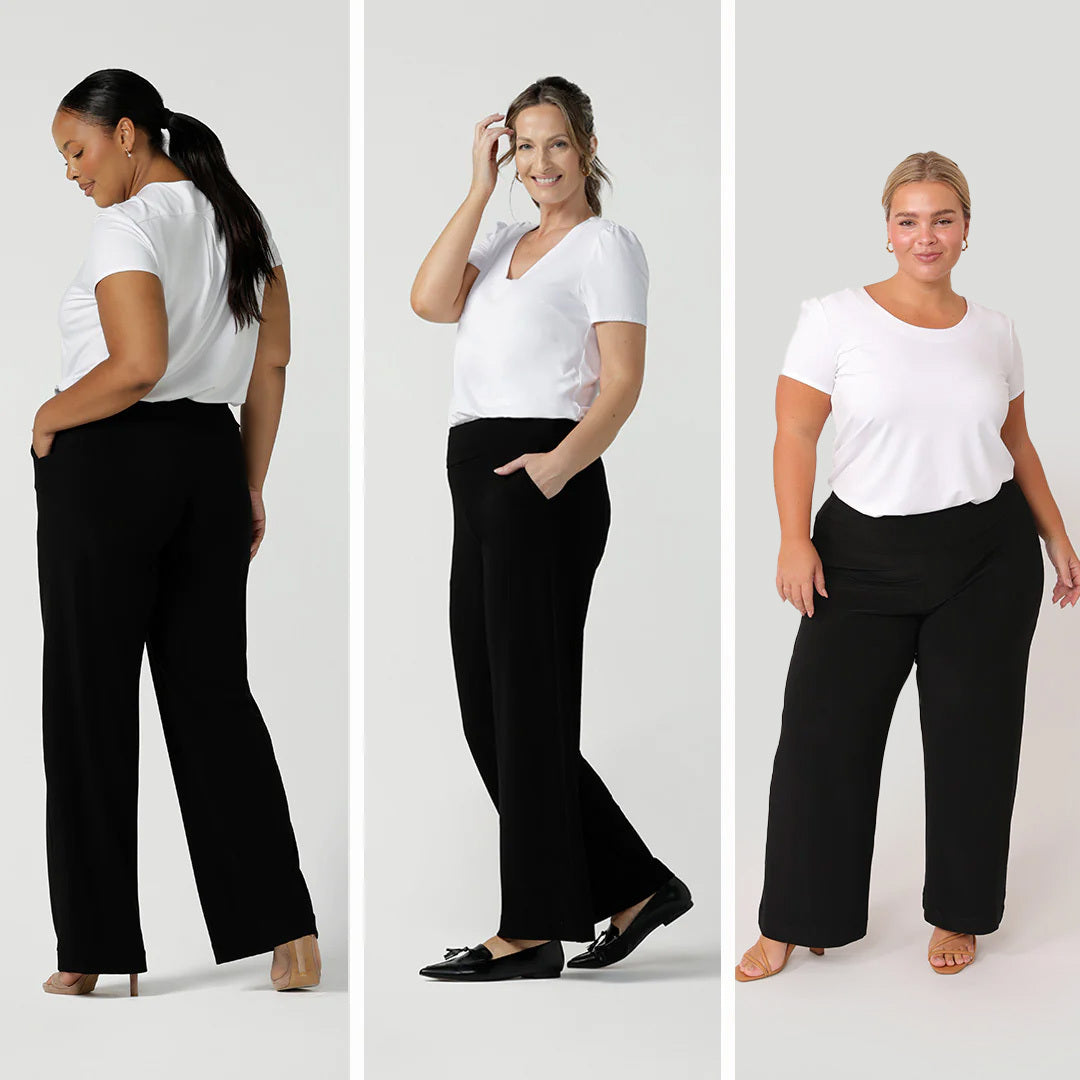 Showcasing Leina & Fleur's best pants for women of all sizes, 3 women wear straight, wide leg pants in different heights. Women one, curvy and plus size, wears wide leg black pants in long length for tall women. Woman 2, over 40 size 10 woman, wears wide leg, black work pants with stretch. Woman 3 wear plus size, petite height black wide leg pants. All black trousers are worn with short sleeve, white tee tops in bamboo jersey and are made in Australia.  