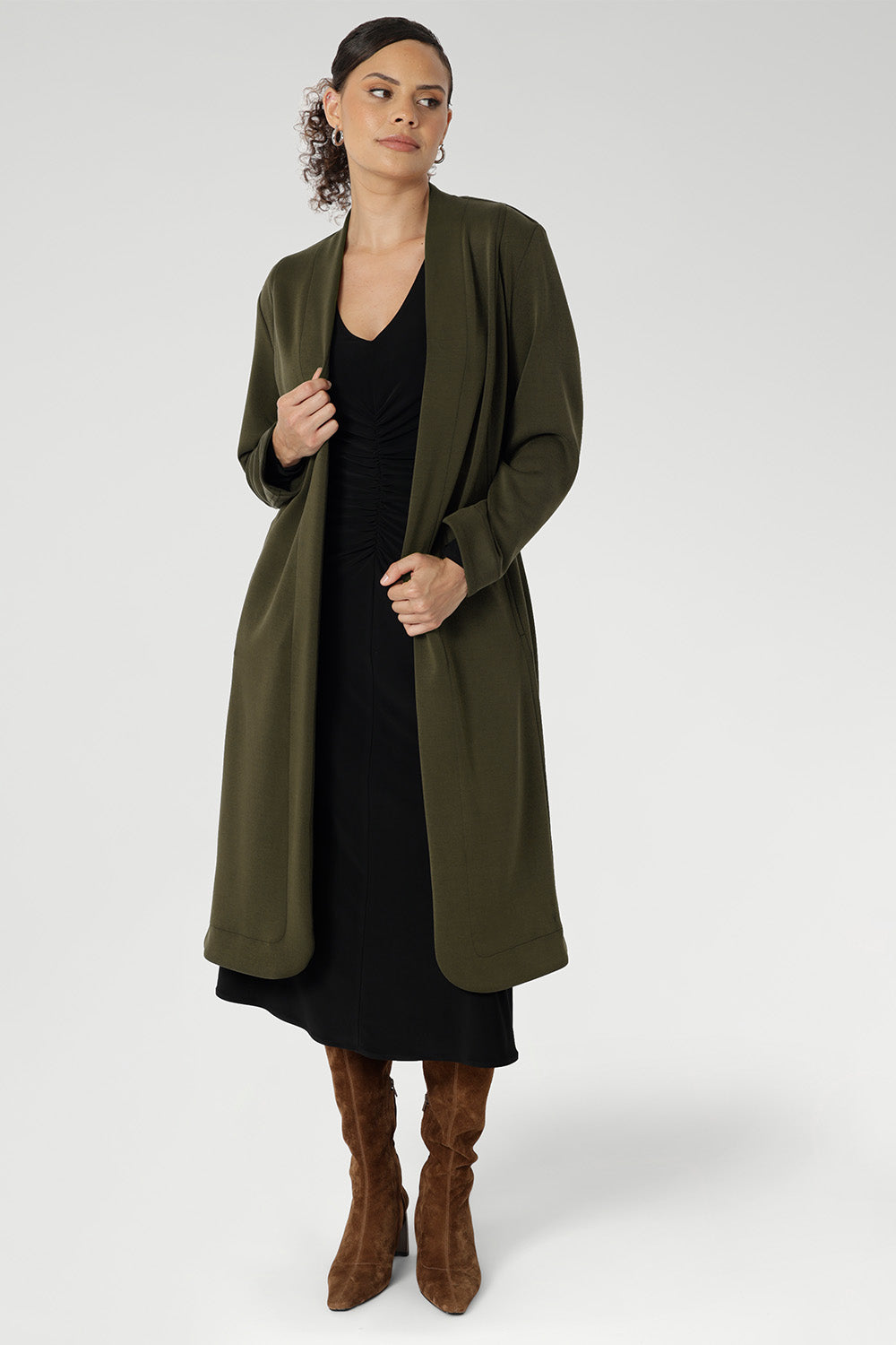 The Nadine Dress is a sophisticated staple, proudly designed and made in Australia from our signature black dry-touch stretch jersey. This timeless piece features a soft A-line silhouette that enhances the figure, while ruched sleeves add a modern, fashion-forward detail. Worn with the Sorel Trenchcoat in Dark Olive. 