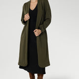 The Nadine Dress is a sophisticated staple, proudly designed and made in Australia from our signature black dry-touch stretch jersey. This timeless piece features a soft A-line silhouette that enhances the figure, while ruched sleeves add a modern, fashion-forward detail. Worn with the Sorel Trenchcoat in Dark Olive. 