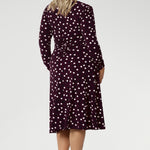 Crafted from high-quality Australian-made jersey fabric, this below-the-knee dress showcases a rich deep burgundy base adorned with a timeless black and white polka dot print, making it a stylish and sophisticated option for the office or any smart-casual occasion.