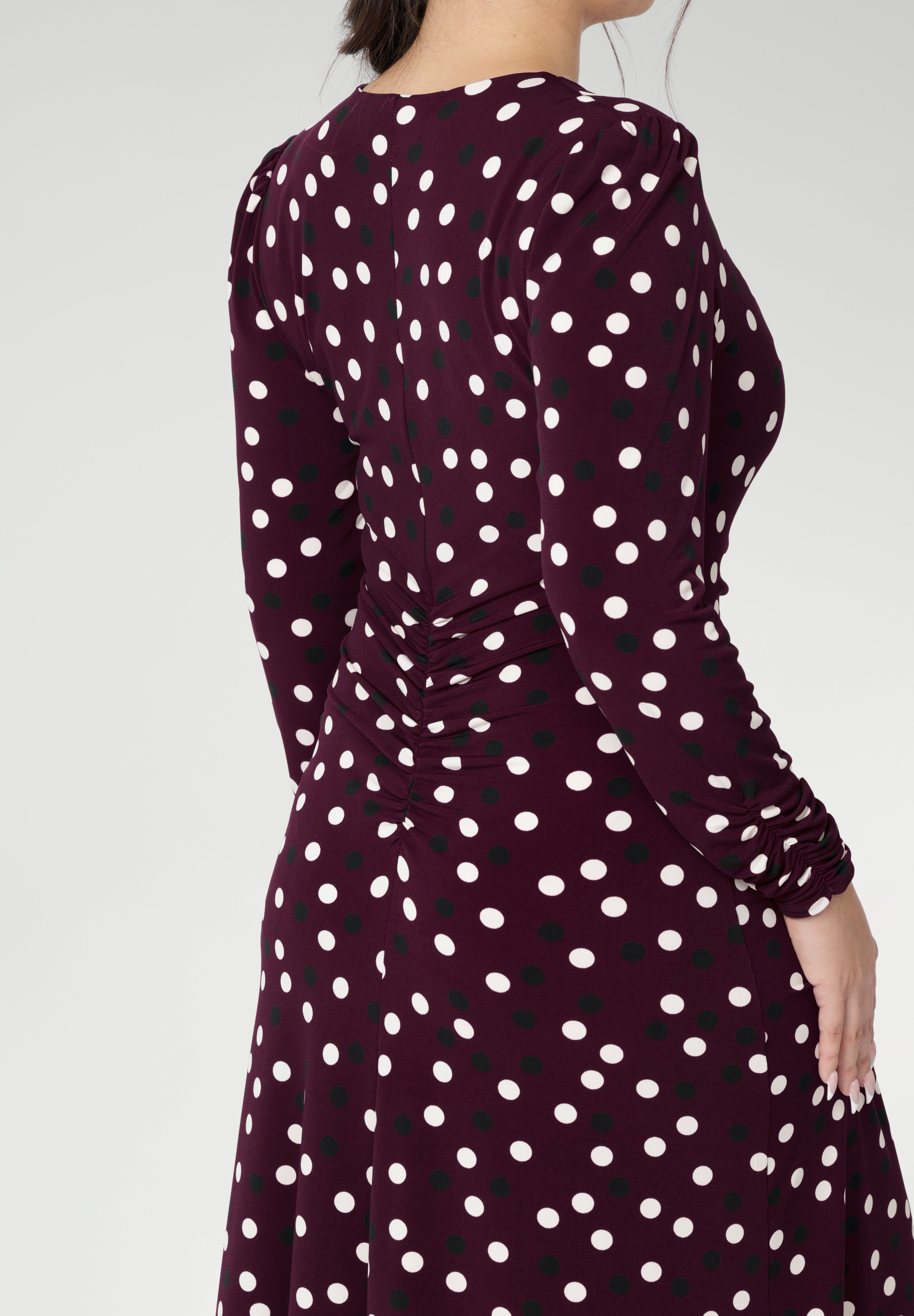 A classic V-neckline and full-length sleeves balance the design, making it perfect for cooler days or layered professional looks. Thoughtfully placed ruched detailing at the front, back, and along the sleeves adds gentle shaping and a touch of textural interest, while enhancing comfort and ease of movement. Available in size 8-24.