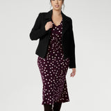 Petite height woman wears workwear dress with thoughtfully placed ruched details at the front, back, and along the sleeves. Which ad gentle shaping and a touch of textural interest, while enhancing comfort and ease of movement.
