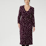 Petite height woman wears workwear dress with thoughtfully placed ruched details at the front, back, and along the sleeves. Crafted from Australian made dry touch jersey. 