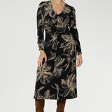 Designed to offer effortless elegance, this softly A-line silhouette features fashion-forward ruched sleeves and a deep, inky floral print in a rich coffee hue that captures the essence of the season.