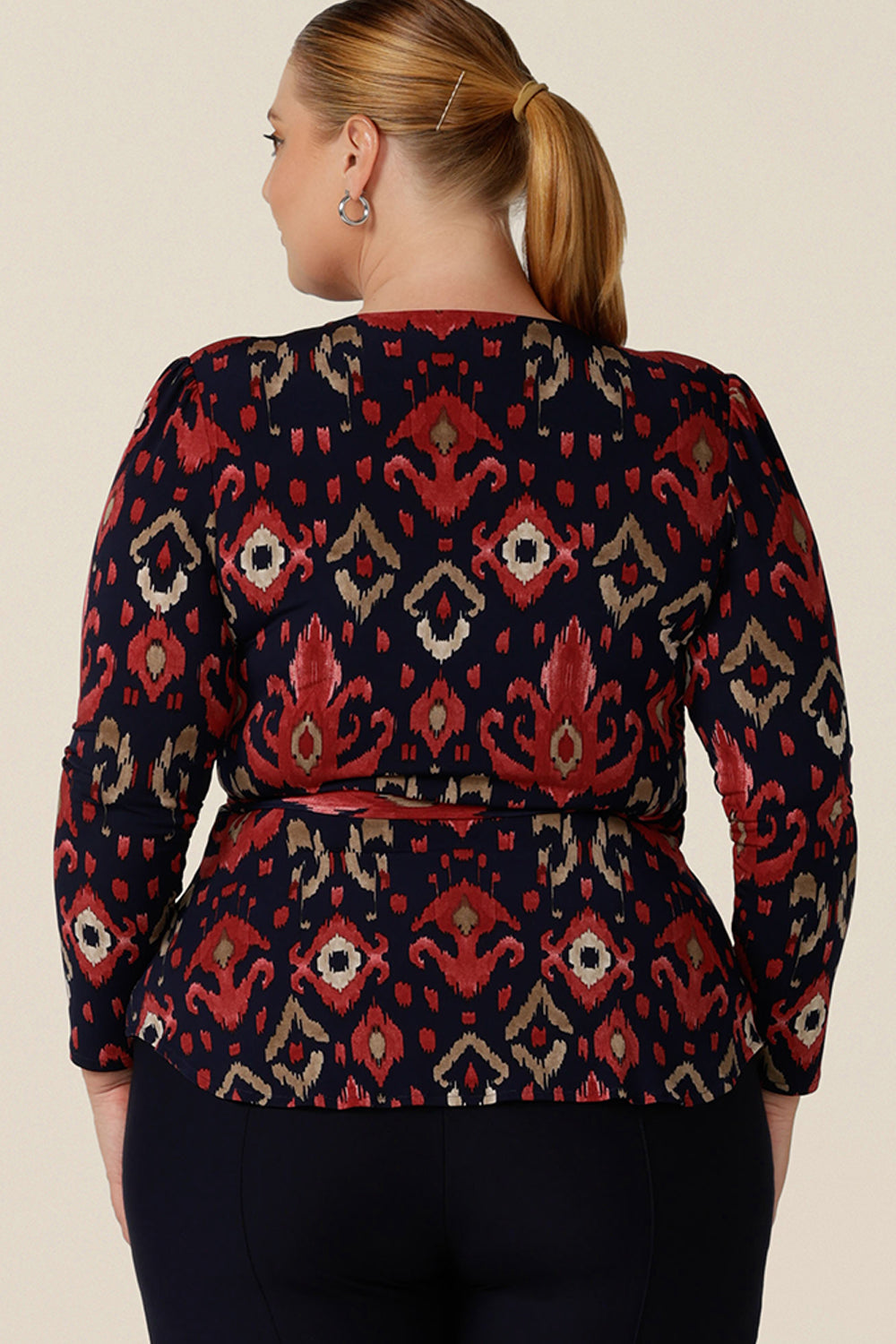Back view of a great top for fuller figure and curvy women, this long sleeve wrap top in Ikat print is comfortable and easy to wear and care for. An elegant workwear top, the Noah Top is made in Australia by Australian and New Zealand women's clothing label, Leina and Fleur.