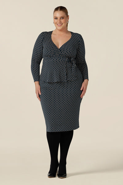 Good work wear for plus size women, a knee-length tube skirt in geometric print is worn with a long sleeve wrap top in matching print. Made in Australia, shop this work skirt online in sizes 8 to 24.