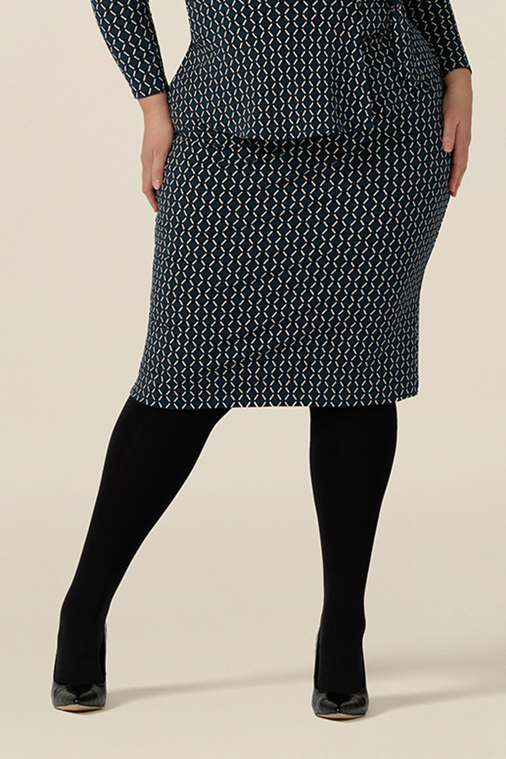 A good office skirt for plus size women, a knee-length tube skirt in geometric print is worn with a long sleeve wrap top in matching print. Made in Australia, shop this work skirt online in sizes 8 to 24.