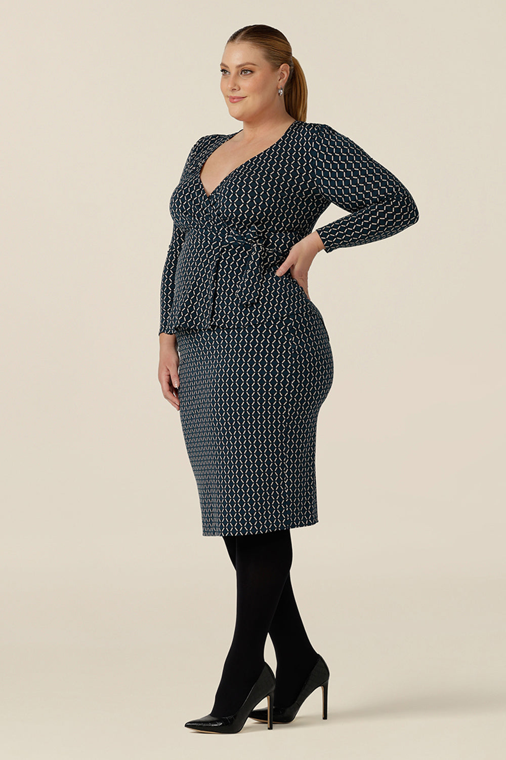 Good work wear for plus size women, a knee-length tube skirt in geometric print is worn with a long sleeve wrap top in matching print. Made in Australia, shop this comfortable corporate skirt online in sizes 8 to 24.