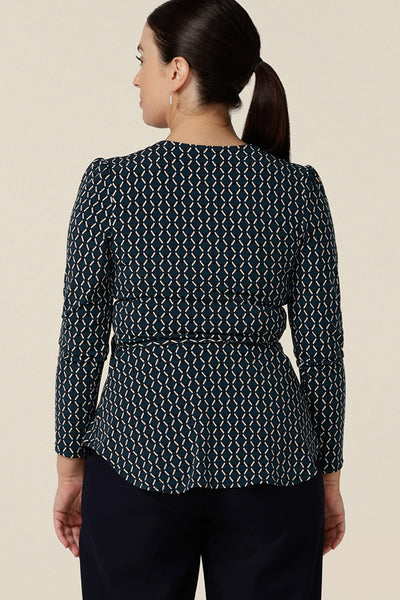 Back view of a wrap top that's perfect for women's work wear capsule wardrobes, this blue and white print jersey top has long sleeves and a peplum hem. Made in Australia, shop this women's work top in sizes 8 to 24.