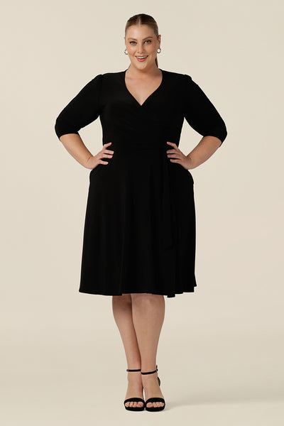 A knee length wrap dress in black jersey looks elegant as an evening and going out dress. Shown for plus sizes, this 3/4 sleeve event dress is made in Australia in dress sizes 8 to 24.