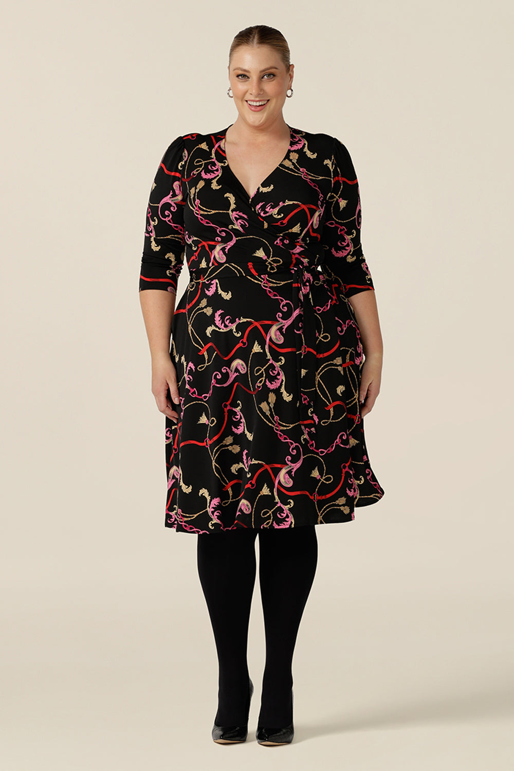 A knee length wrap dress in rococo print jersey looks sassy for work and as a going out dress. Shown for plus sizes, this 3/4 sleeve wrap dress is made in Australia in dress sizes 8 to 24.