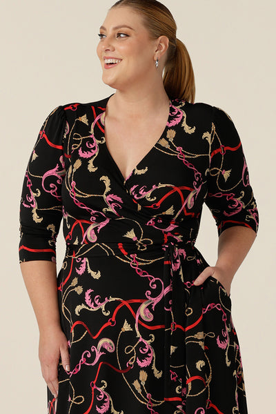 Close up of the belt waist and pockets of a knee length wrap dress in rococo print jersey.  Looking sassy for work and or as a going out dress, this 3/4 sleeve wrap dress is made in Australia and shown for plus size women.