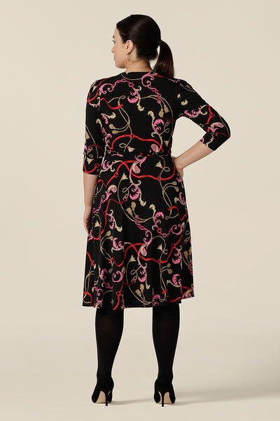 Back view of a knee length wrap dress in rococo print jersey. Sassy as a work dress or going out dress, this 3/4 sleeve wrap dress is made in Australia in dress sizes 8 to 24.