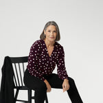 The Paeton Top in burgundy spot is a standout piece in our women’s workwear collection, designed to bring ease and elegance to your everyday wardrobe. Made in Australia from a premium soft-touch jersey fabric, this stylish top offers a relaxed fit with the option to size down for a more structured, tailored silhouette.