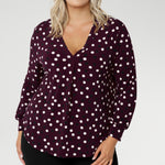 The Paeton Top in burgundy spot is a standout piece in our luxe separates collection, combining everyday comfort with elevated design. Crafted from a premium soft-touch jersey fabric with gentle stretch, this functional women’s top is designed for a relaxed fit—though you can size down for a more tailored silhouette.