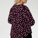 At the back, a shoulder yoke flows into a centre-back tuck, offering subtle detail and a touch of sophistication. The curved shirttail hemline enhances versatility, making it perfect for layering over pants or skirts without the need to tuck in.