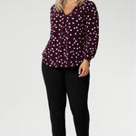 A flattering V-neckline is enhanced by a precisely placed tailored tuck at the centre front, adding both structure and shape. The long sleeves are finished with a refined cuff, creating a polished, professional look ideal for work or smart casual wear. At the back, a shoulder yoke flows into a centre-back tuck, offering subtle detail and a touch of sophistication.