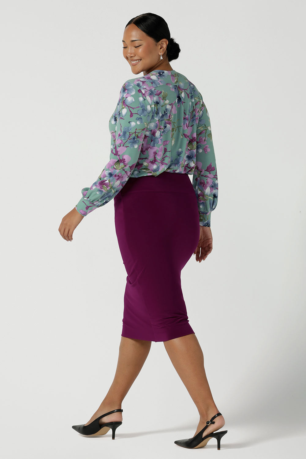 Back view of a size 10 woman wears the Andi skirt in Magenta. A made in Australia skirt styled back with the Paeton top in Day Bloom. Size 8 - 24.