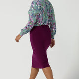 Back view of a size 10 woman wears the Andi skirt in Magenta. A made in Australia skirt styled back with the Paeton top in Day Bloom. Size 8 - 24.