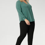 Paeton is ideal for workdays, weekend styling, and effortless winter layering. Available in sizes 8 to 24. Plus size woman wear  Paeton Top in Menthol with black tapered leg pants and black kitten heels - Creating a go to work look. 