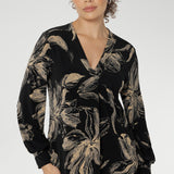 Discover effortless elegance with the Paeton Top, a signature piece from our luxe separates collection. Expertly crafted in Australia from premium black dry-touch jersey, this top combines soft stretch with a flattering, relaxed fit that drapes gracefully on the body. The deep, inky floral print in a rich coffee hue brings a moody seasonal edge, while refined design details—such as the V-neckline with a tailored front tuck, long sleeves with cuffs, a structured shoulder yoke, and a curved shirttail hem.