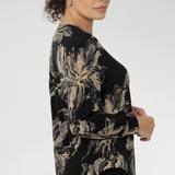 Paeton features refined design details such as the V-neckline with a tailored front tuck, long sleeves with cuffs, a structured shoulder yoke, and a curved shirttail hem.
