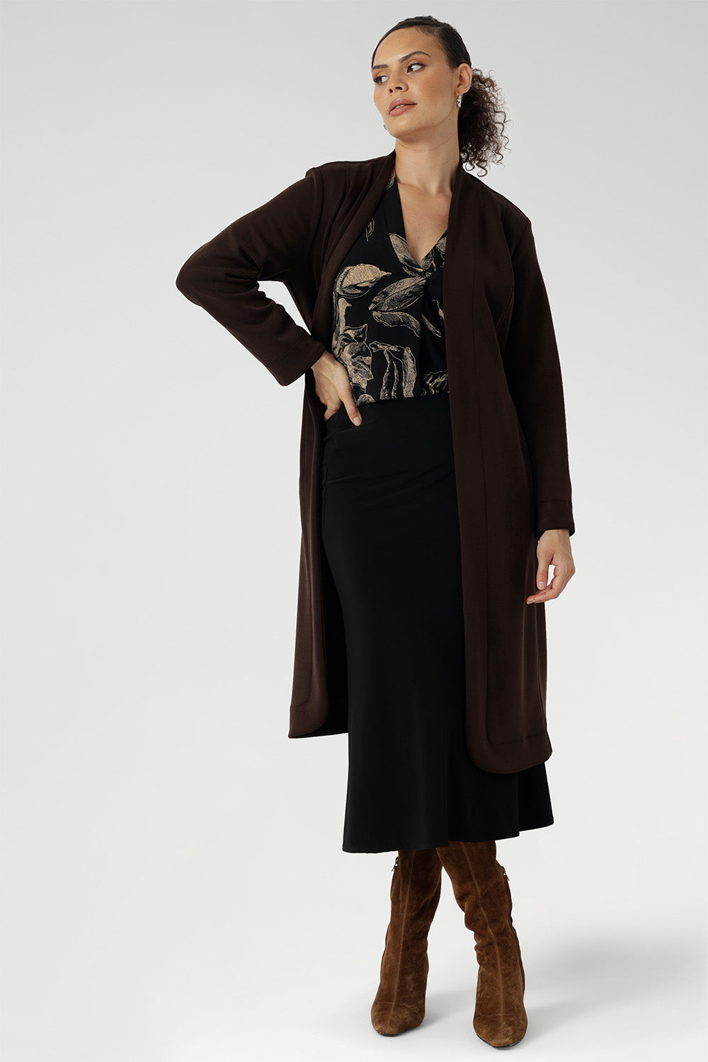 The rich coffee-hued floral print adds a bold, inky elegance that captures the essence of the season. Paeton features a polished style to your everyday wardrobe. Size 10 model wears brown trenchcoat for a warm winter look.