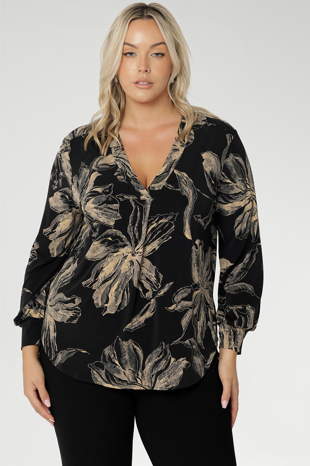 The rich coffee-hued floral print adds a bold, inky elegance that captures the essence of the season. Thoughtfully designed with a V-neckline and a centre-front tailored tuck, long sleeves with cuffs, a shoulder yoke with a back tuck, and a curved shirttail hem, the Paeton Top brings polished style to your everyday wardrobe.