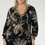 The rich coffee-hued floral print adds a bold, inky elegance that captures the essence of the season. Thoughtfully designed with a V-neckline and a centre-front tailored tuck, long sleeves with cuffs, a shoulder yoke with a back tuck, and a curved shirttail hem, the Paeton Top brings polished style to your everyday wardrobe.