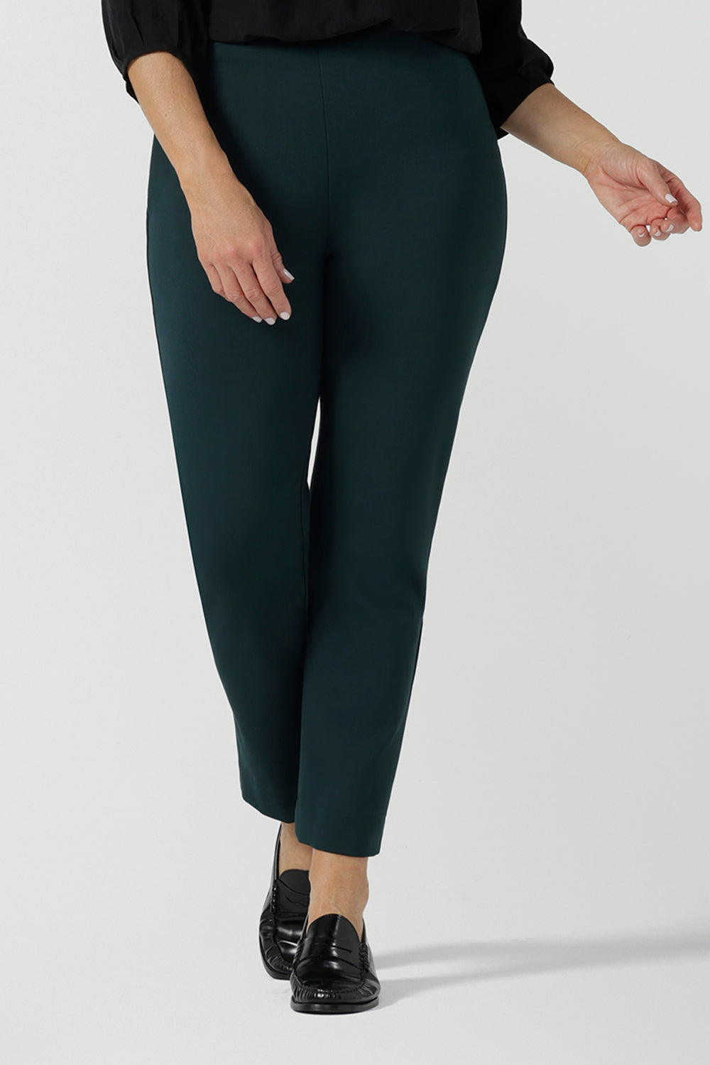 A size 10 woman wears the Paxton Pant for travel wear. Made in Ponte jersey and made in Australia for women size 8-24. Comfortable workwear for women, size inclusive fashion label Leina & Fleur. Styled back with the Ellis Shirt in Black Tencel.