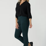 A size 10 woman wears the Paxton Pant for travel wear. Made in Ponte jersey and made in Australia for women size 8-24. Comfortable workwear for women, size inclusive fashion label Leina & Fleur. Styled back with the Ellis Shirt in Black Tencel