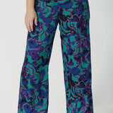 Good pants for petite height women, these wide leg printed pants are part of a coord set. The abstract design of the set displays navy, pink and aqua blue colours. This Australian made shirt and pant set is made from satin rayon fabric that is breathable and comfortable. Leina and Fleur is a women’s clothing company that actively stocks plus sizes & petite sizes ranging from 8 to 24.