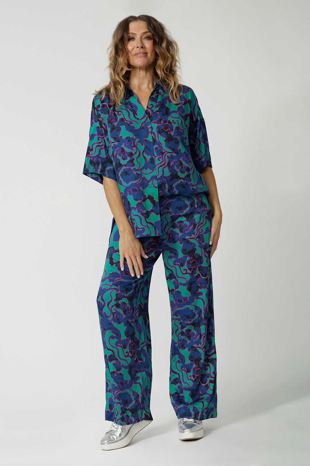 A good coord set for over 40s women, this oversized shirt and wide leg pant set is shown on a size 12 woman. Made from silky rayon-satin, this easy care shirt is made in Australia by Australian and New Zealand women's clothes brand, Leina & Fleur. Shop shirts online in petite to plus sizes